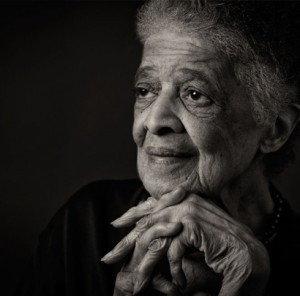 Image description: A black-and-white headshot of Vel Phillips resting her head on her folded hands.