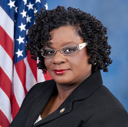 Image description: A portrait-style photo of Gwen Moore in front of an American flag.