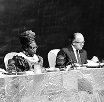 Image description: A black-and-white photo of Angie Brooks sitting at the United Nations general assembly.