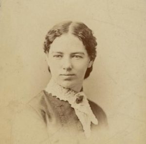 Image description: A black-and-white headshot of Clara Bewick Colby.