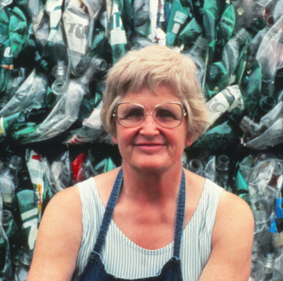 Image description: A portrait-style photo of Millie Zantow in front of a wall of plastic bottles.