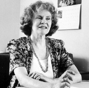 Image description: A black-and-white photo of Anne Nicol Gaylor sitting at a desk.